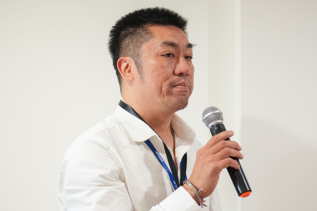 A guest speaking to the room with a microphone