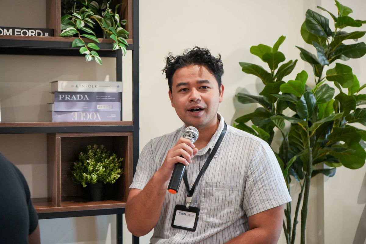 A guest speaking to the room with a microphone