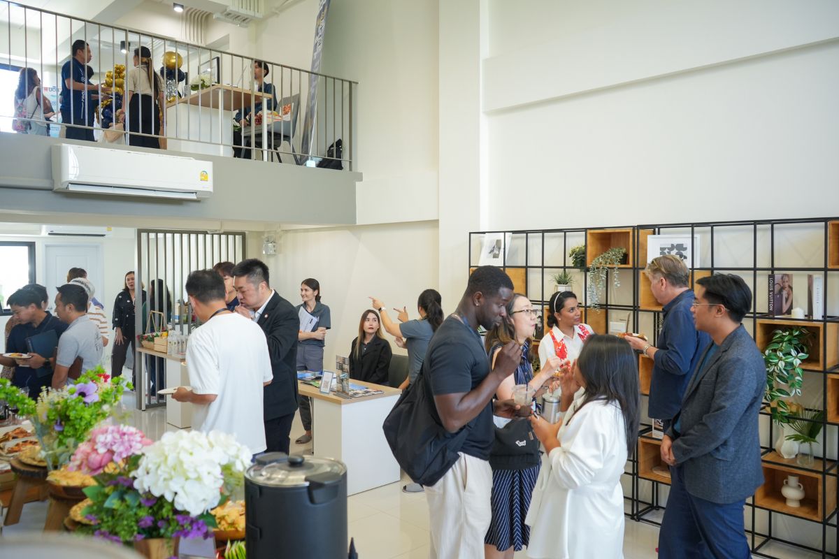 CMBN members and guests talking across two floors at a CMBN gathering